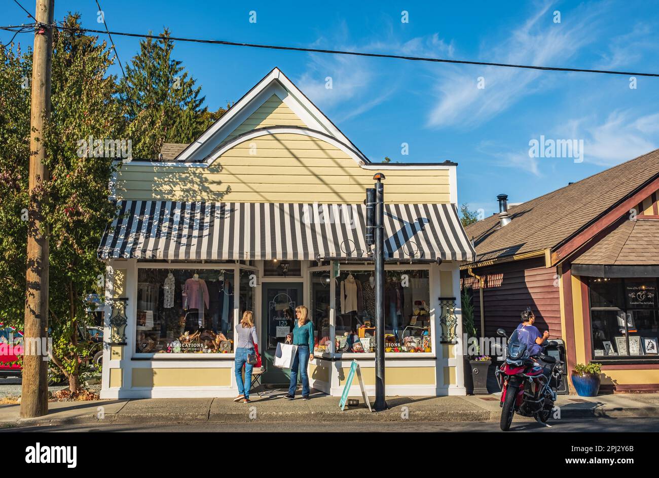 Old city view with old shops on a Sunny Summer Day in Duncan BC Canada. Real people on a street of old town. Travel photo-October 6,2022 Stock Photo