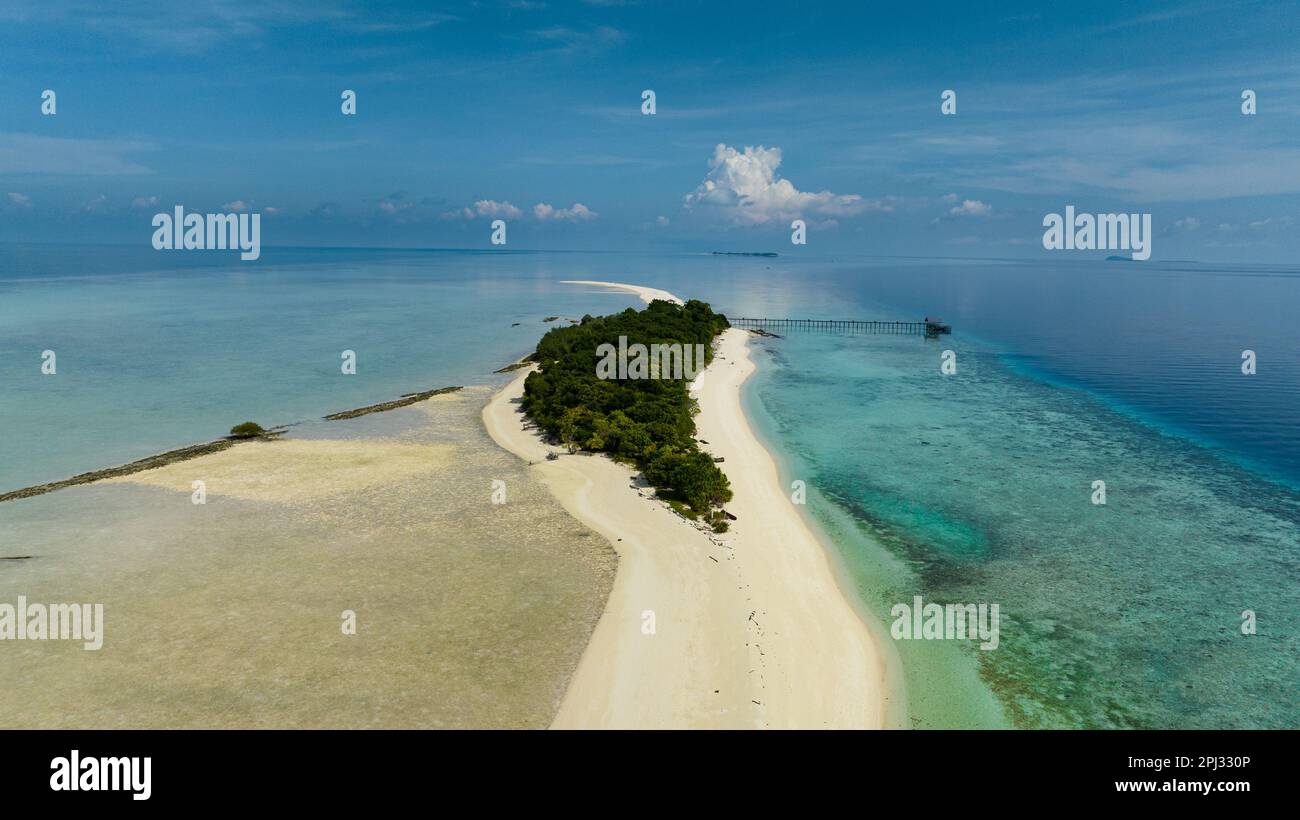 Aerial view of sandy tropical island with a beautiful beach surrounded ...