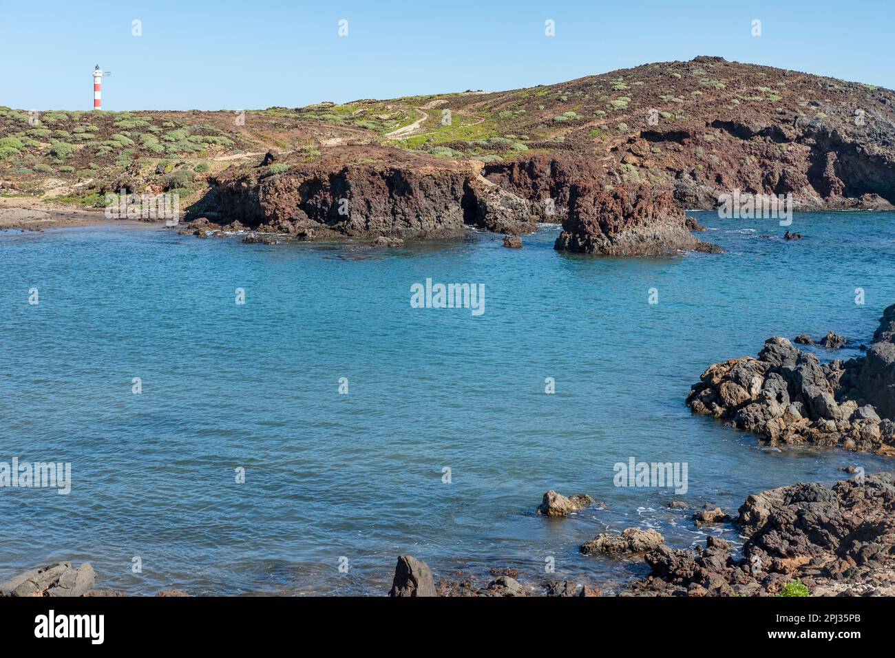 Tranquil landscape near Faro de Punta Abona, wild natural land with endemic flora, surrounded by volcanic coast, wild walking route through nature Stock Photo
