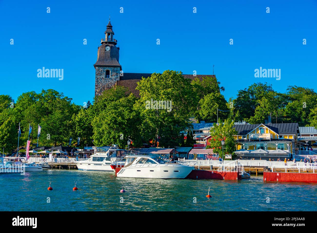Naantali Naantali, Finland, July 29, 2022: Naantali church viewed over marina in ...