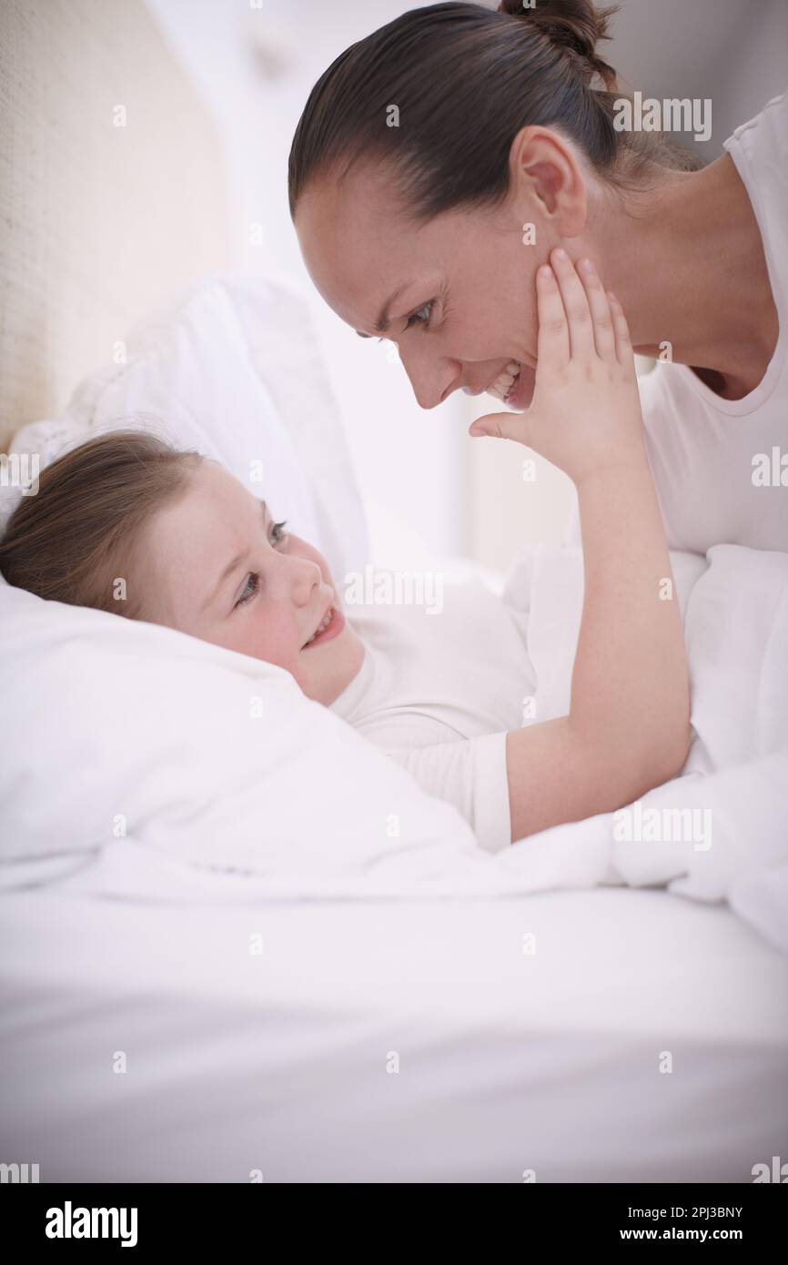 Im not afraid of the dark, Mom. A mother saying goodnight to her young daughter. Stock Photo