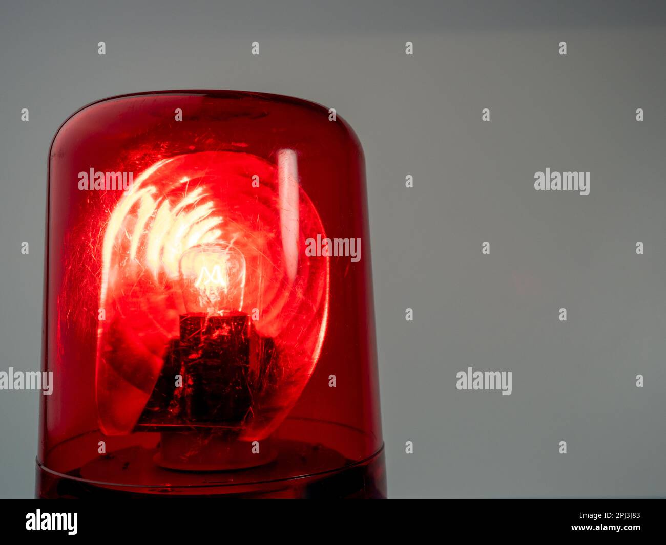 Red rotating beacon. Red flashing light. Warning signal. Closeup Stock