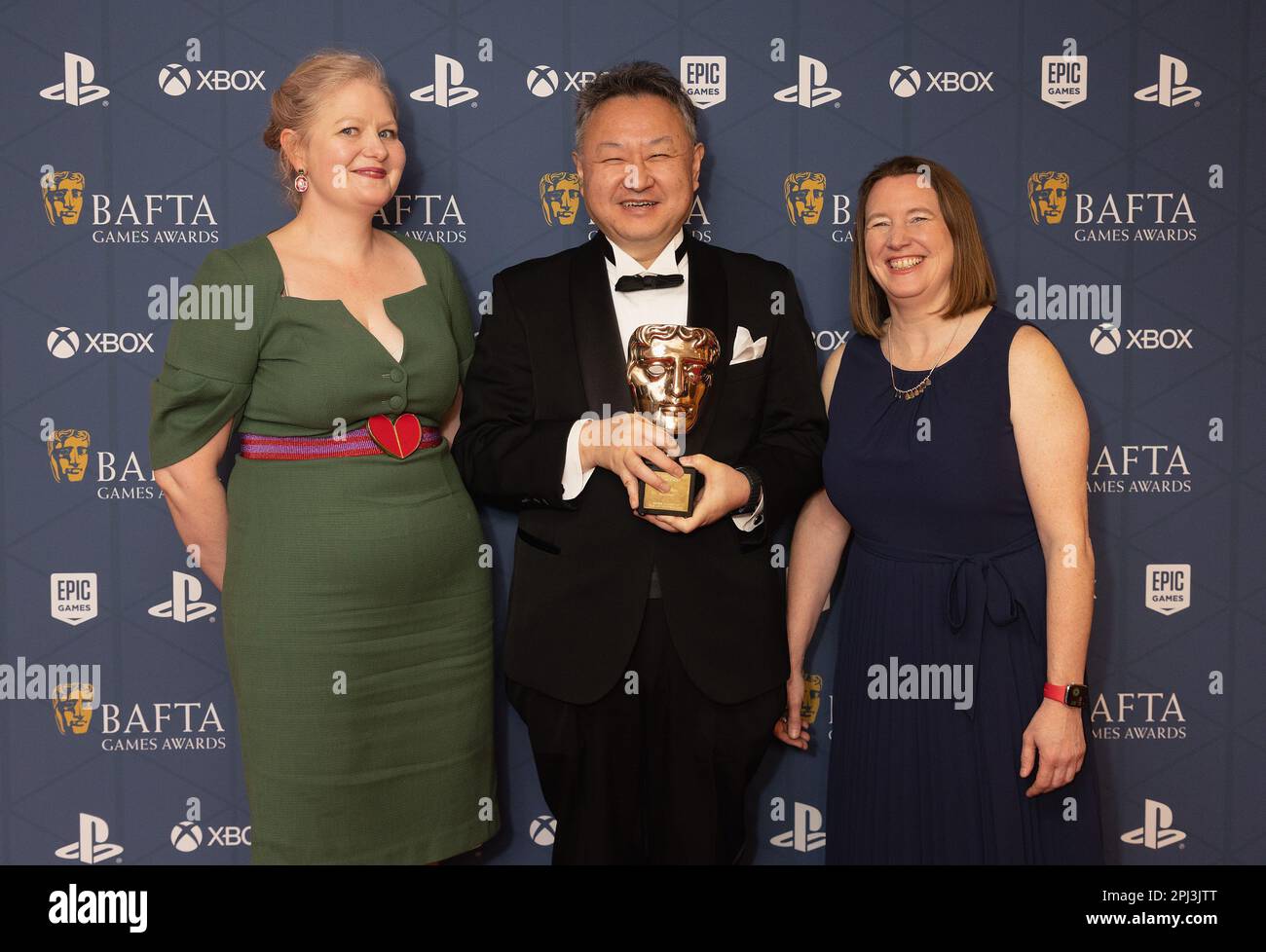 (L-R) Tara Saunders, Shuhei Yoshida wins the Games Fellowship Award and Siobhan Reddy during the BAFTA Games Awards at the Queen Elizabeth Hall, Southbank Centre, London. Picture date: Thursday March 30, 2023. Stock Photo