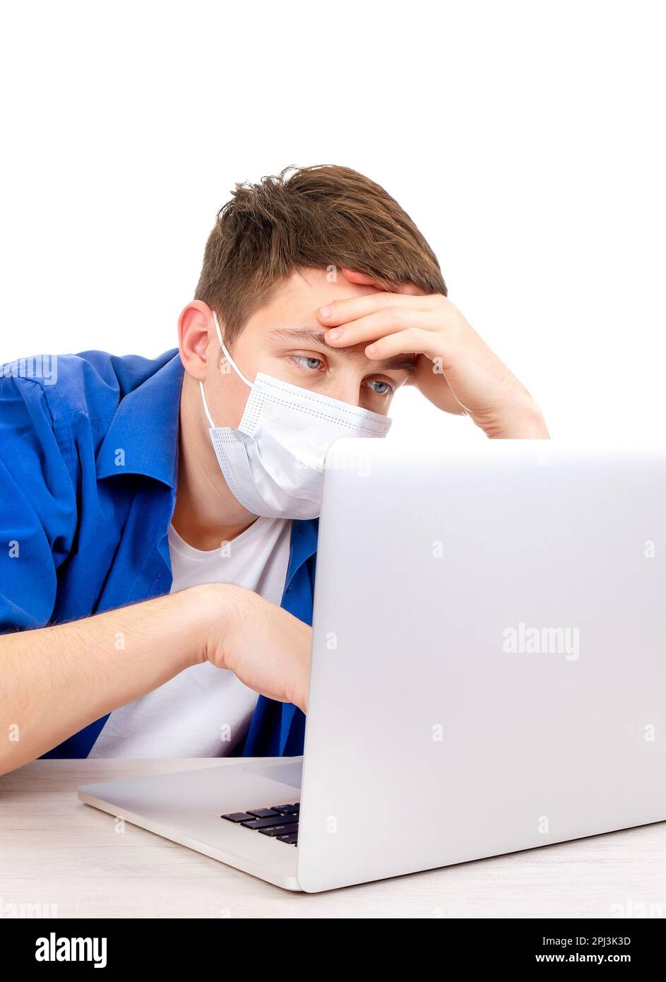 Tired Young Man in Flu Mask with Laptop Isolated on the White Background Stock Photo