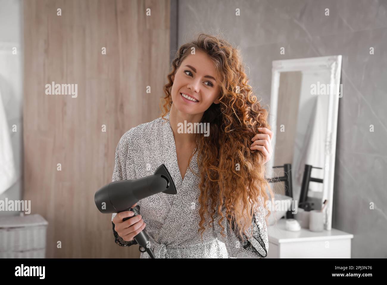 Woman with hair dryer hi-res stock photography and images - Alamy