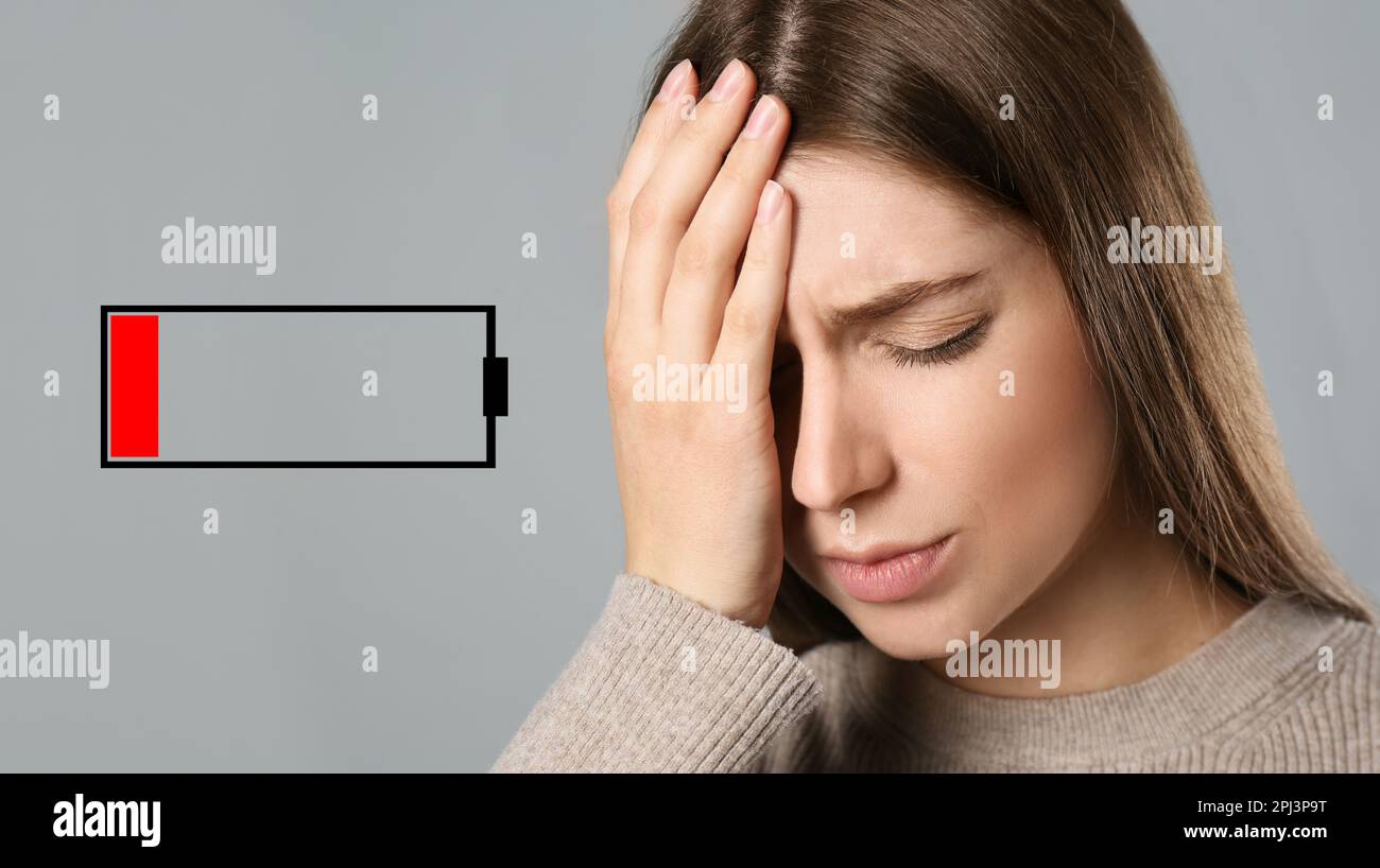 Illustration of discharged battery and tired woman on light grey