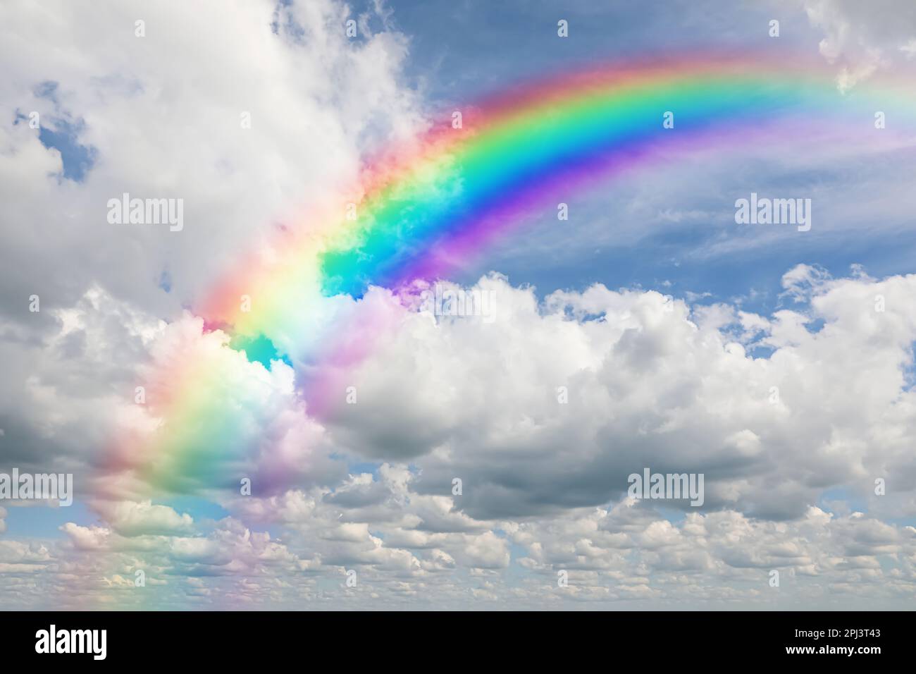 Beautiful view of bright rainbow in blue sky on sunny day Stock Photo ...