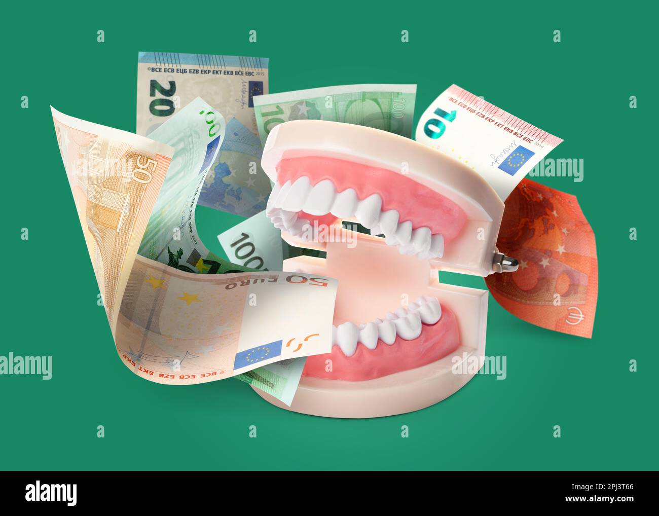 Model of oral cavity with teeth and euro banknotes on green background