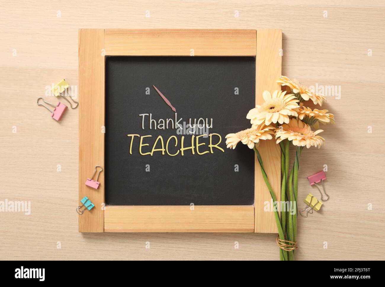 Small blackboard with phrase Thank You Teacher, flowers and color paper ...