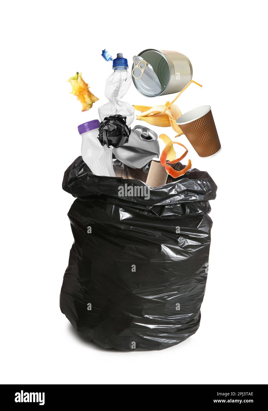 Different garbage falling into trash bag on white background Stock