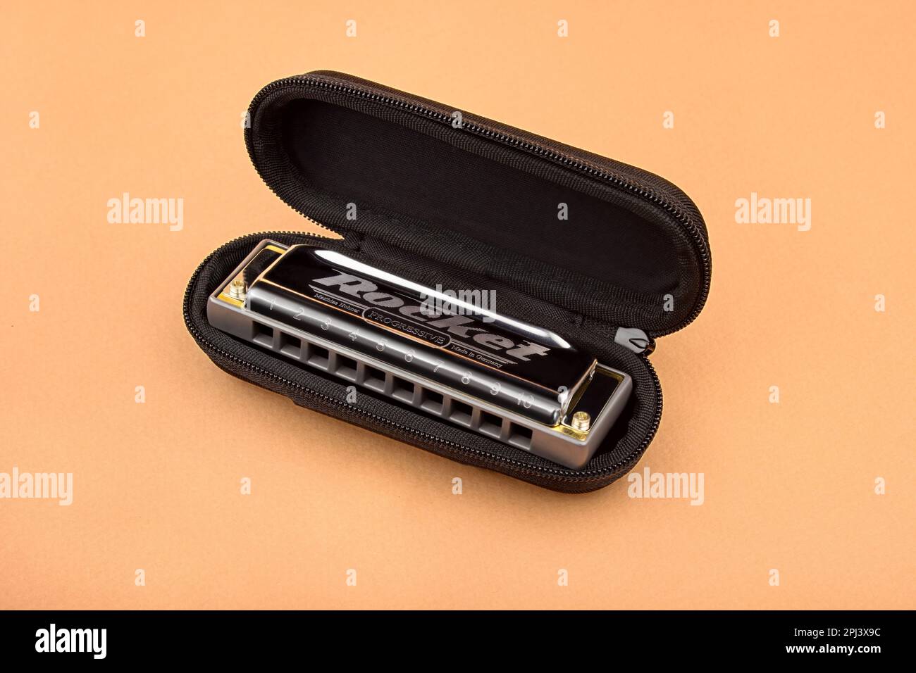 Hohner professional diatonic Rocket harmonica lies in an open black