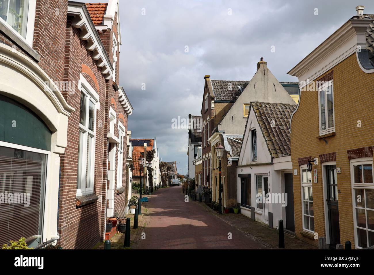 Old houses in the Dorpsstraat in village Moordrecht as part of the Dyke along river Hollandsche IJssel in the Netherlands Stock Photo