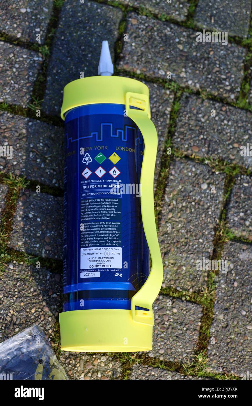 nitrous oxide or laughing gas cylinder for recreational drug usage left