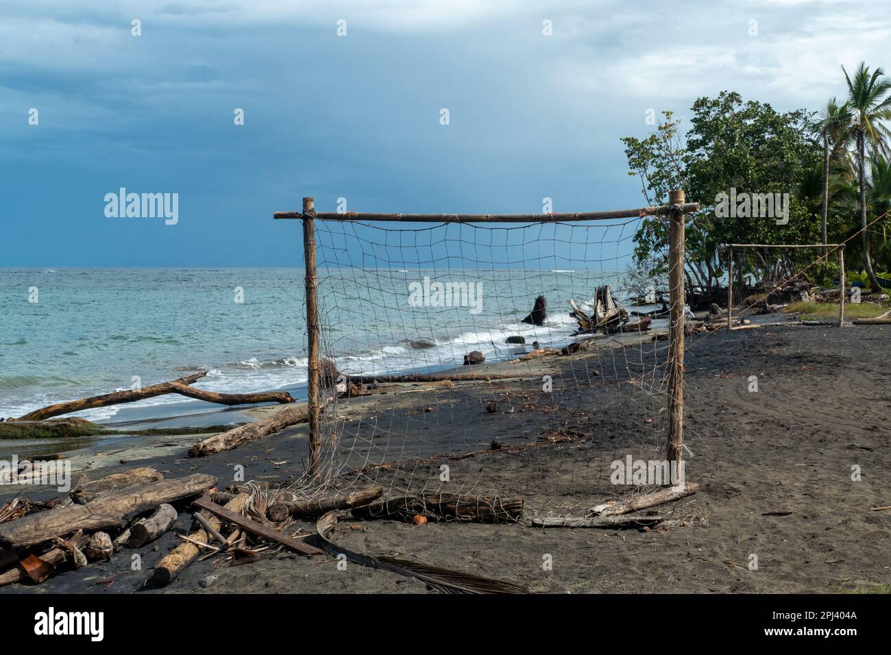 scenic  beach of Cocles on the Caribbean side of Costa Rica, Puerto Viejo de Talamanca with an handmade soccer coal made of palm trees Stock Photo