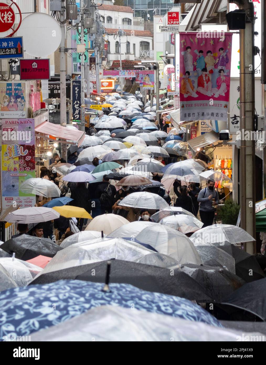 View along Takeshita Street with many umbrellas in the rain in Harajuku, Tokyo, Japan Stock Photo