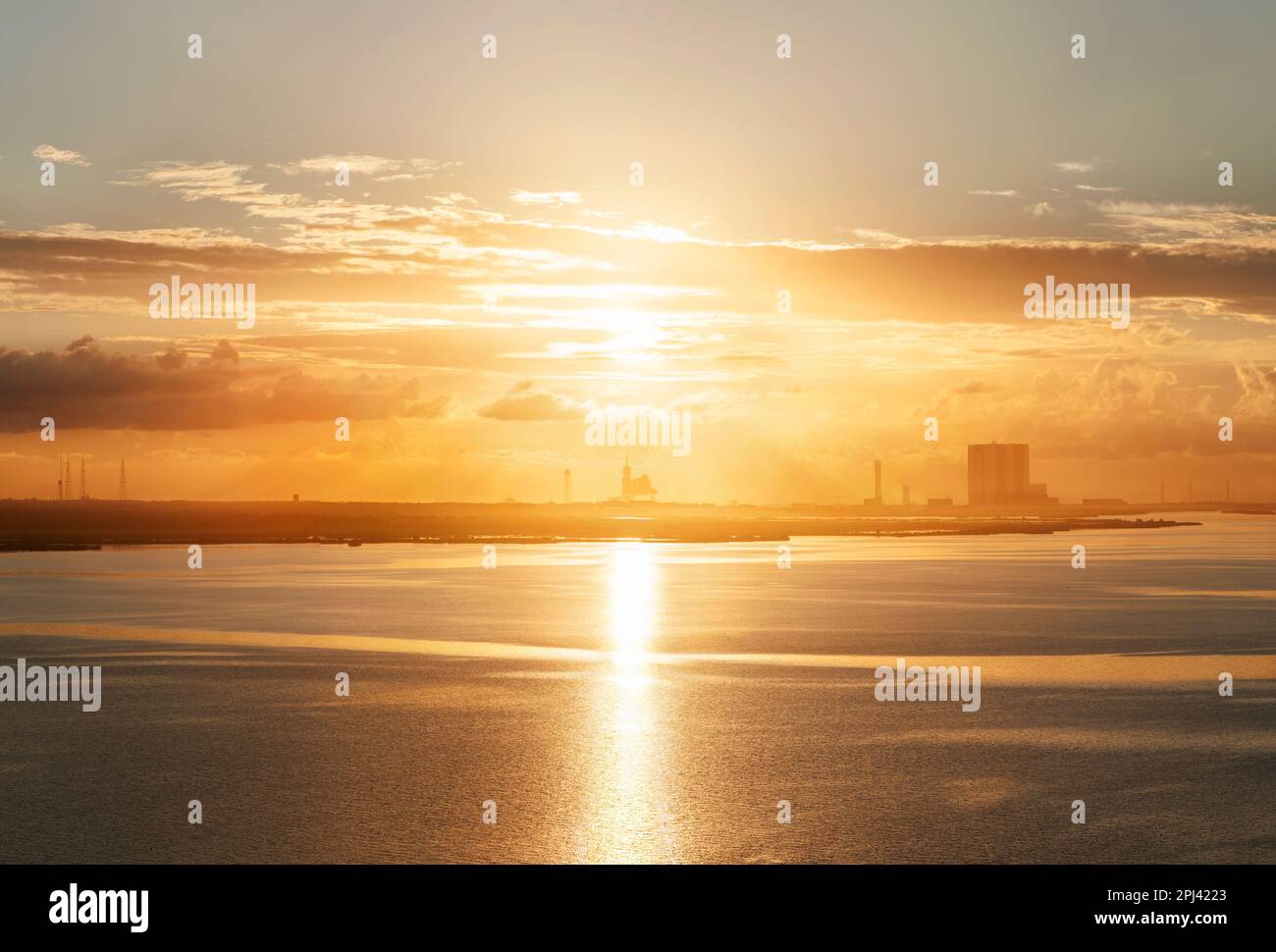 Sunrise over NASA Kennedy Space Centre, Cape Canaveral, Florida. With the sun directly over Pad39a and the Vehicle Assembly Building the the right Stock Photo