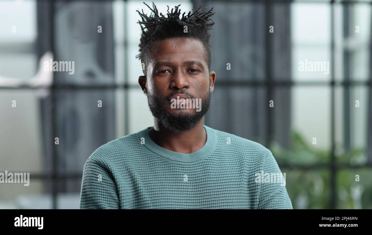 Thoughtful young black man looking straight ahead Stock Photo