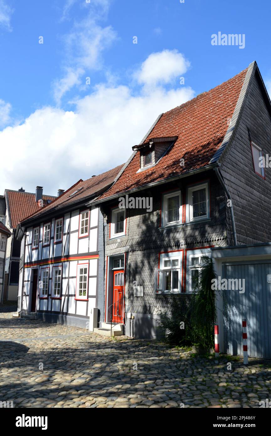 Germany, Lower Saxony, Goslar:   timber-framed houses, the nearest one with traditional slate cladding on the facade, in a street of cobblestones in t Stock Photo