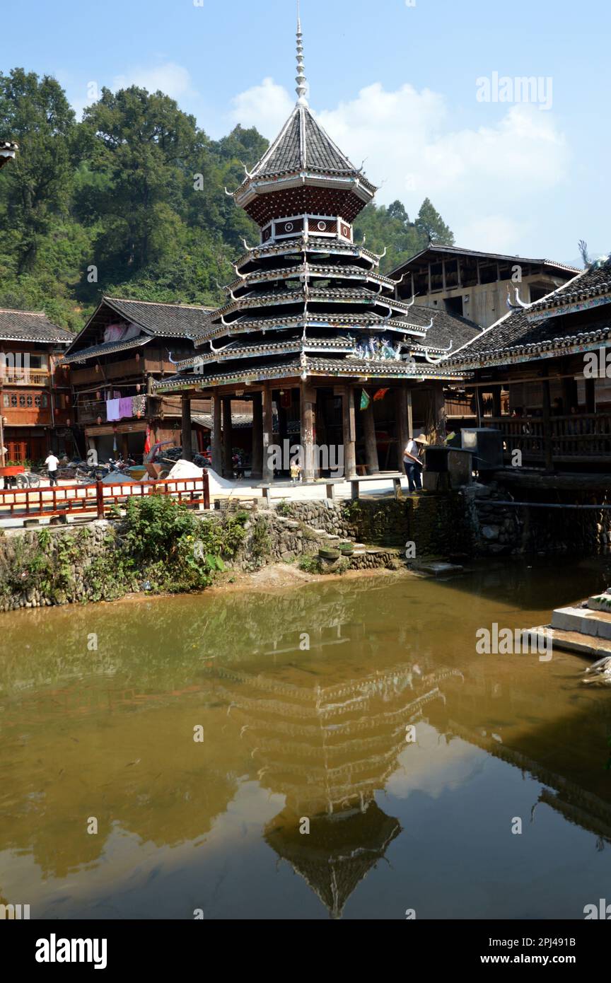 People's Republic of China, Guizhou Province,  Zhaoxing Dong Village:  the 'Drum Tower', reflected in the pool. Stock Photo