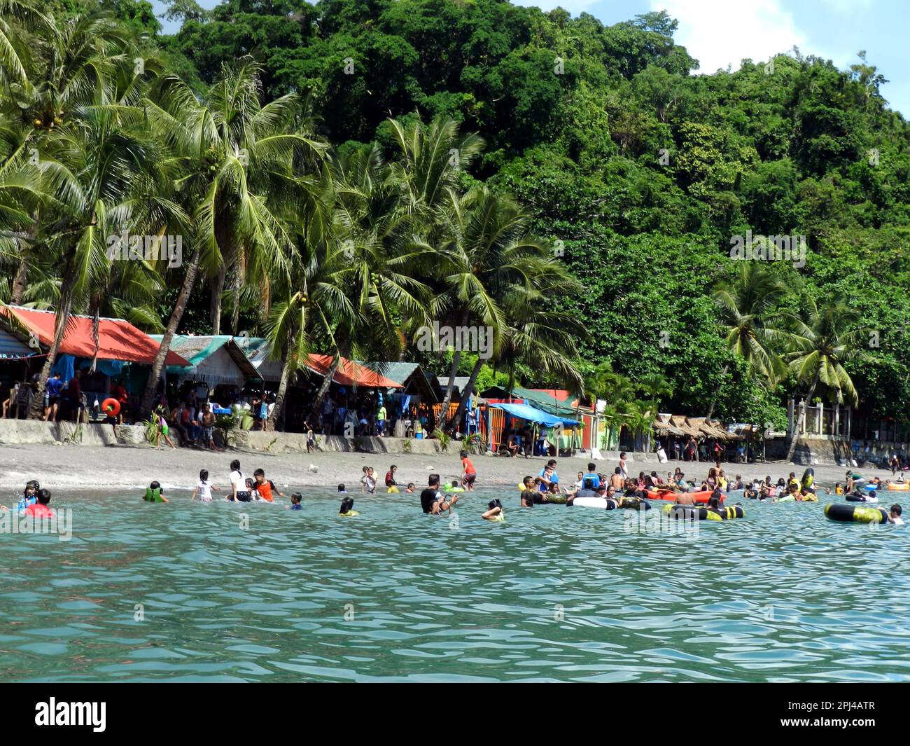 The Philippines, Samar Island bathers in the sea off Malajog Beach
