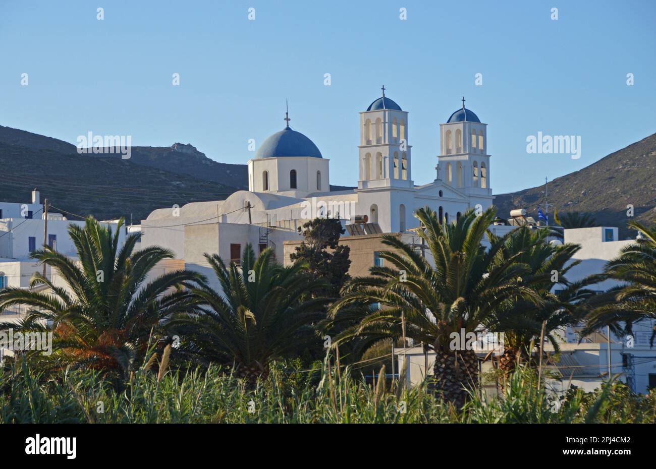 Greece, Island of Amorgos:  early morning view of the twin belltowers and dome of the Orthodox church at Katapola. Stock Photo