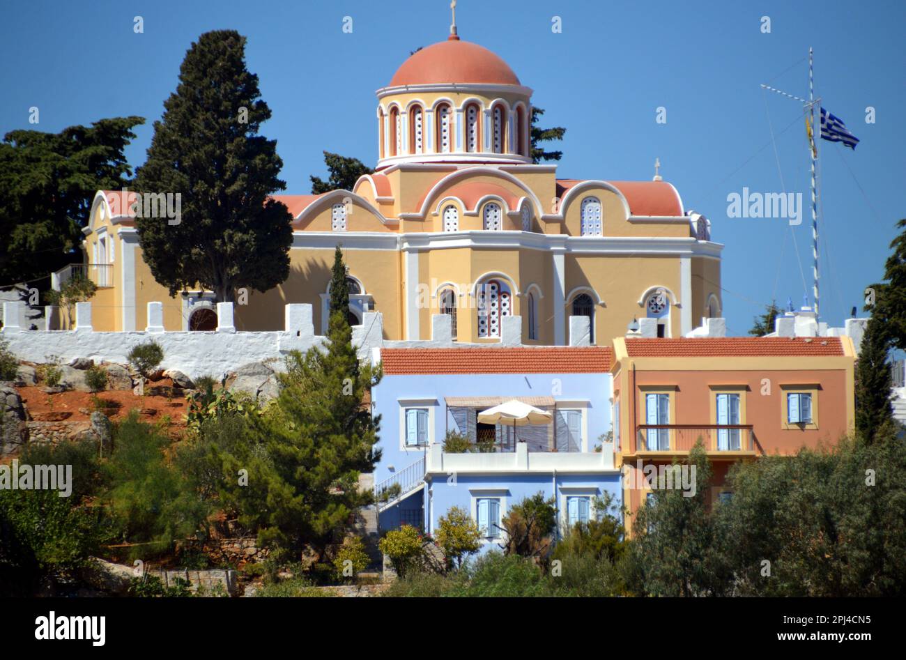 Greece, Island of Symi, Gialos:  Orthodox church on the headland between the two bays. Stock Photo
