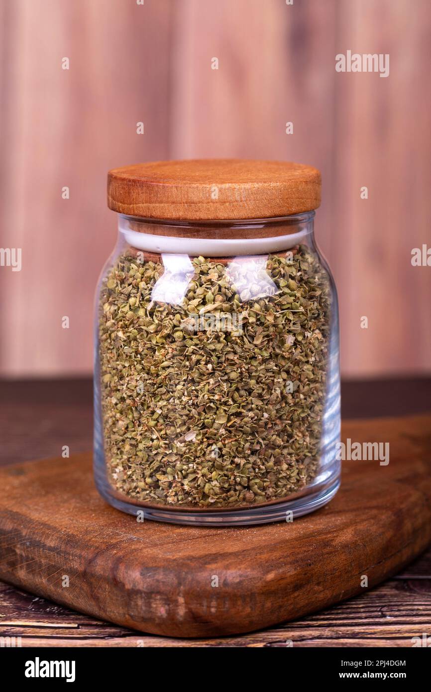 Thyme spice. Dried Thyme leaf in glass jar on wood background. Spice