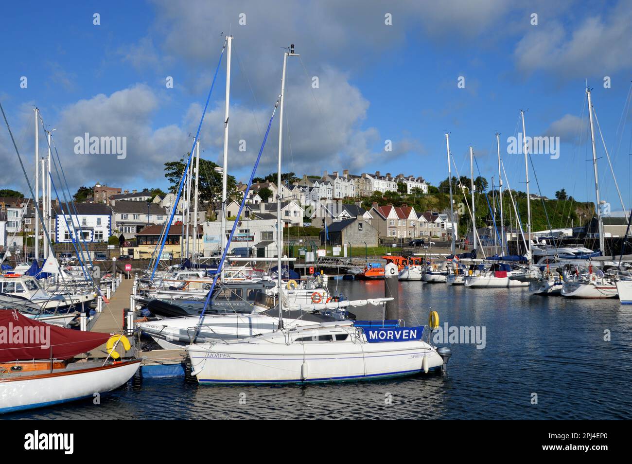 Northern Ireland, County Antrim, Ballycastle:  yachts moored in the harbour, overlooked by the rising ground of the town. Stock Photo