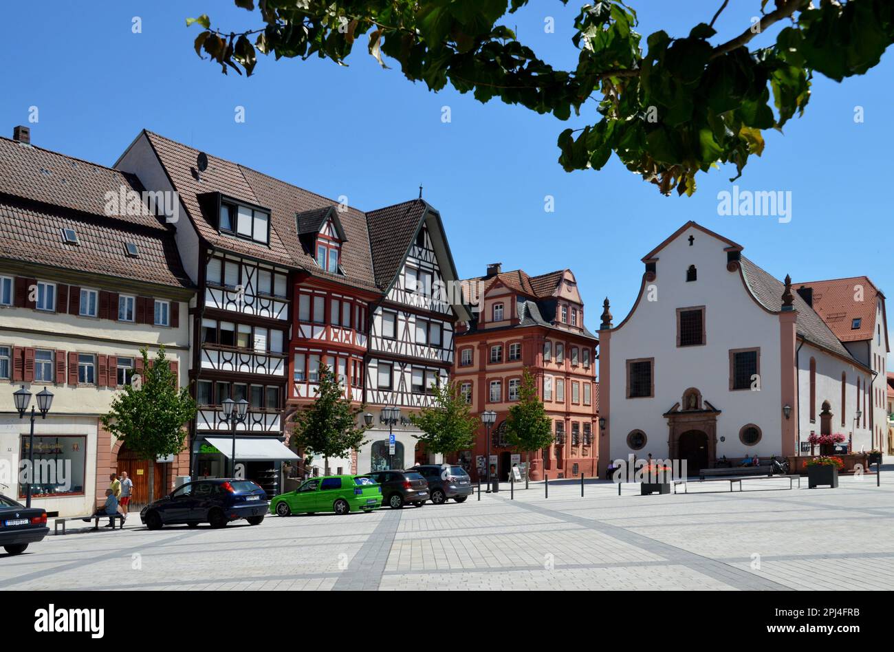 Germany, Baden-Württemberg, Tauberbischofsheim:   mediaeval timber-frame houses on the Market Place, with the Baroque church of St. Lioba at the far e Stock Photo