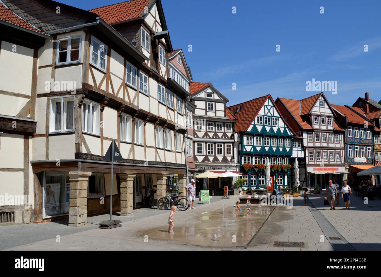 Germany, Niedersachsen, Wolfenbüttel:    street fountains help to keep cool:  timber-frame houses on Krambuden (Street). Stock Photo