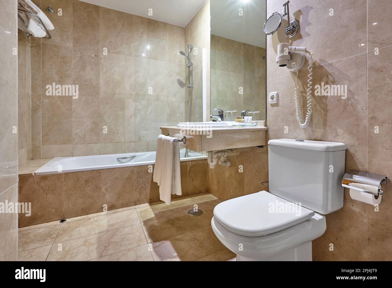 Hospital bathroom finished in marble. Shower, lavatory, wash hand basin Stock Photo