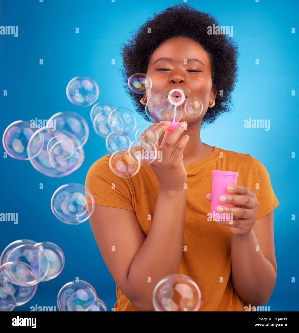 Fun, bubbles and black woman with joy, positive attitude and happiness