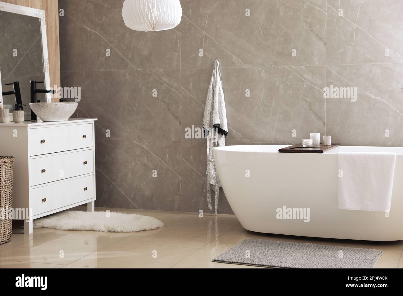 Modern white tub and chest of drawers with sink in bathroom. Interior ...
