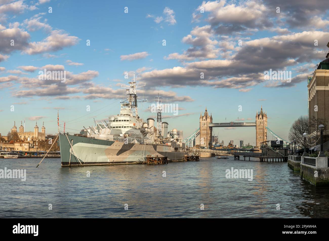 HMS Belfast moored on the River Thames alongside The Queens Walk in the Pool of London, Southwark. HMS Belfast is a Town-Class light cruiser that was Stock Photo