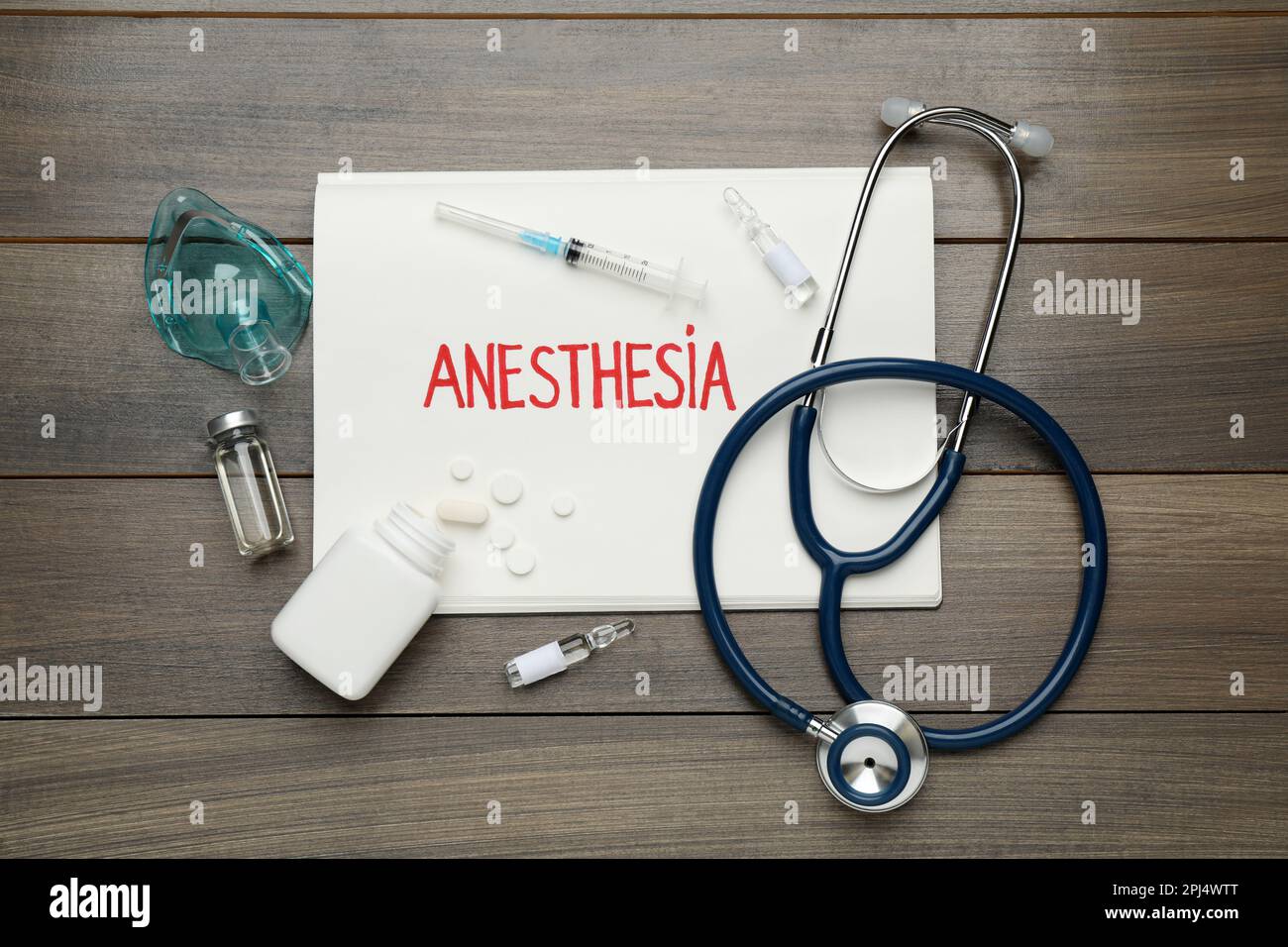 Flat lay composition with word Anesthesia and drugs on wooden table Stock Photo