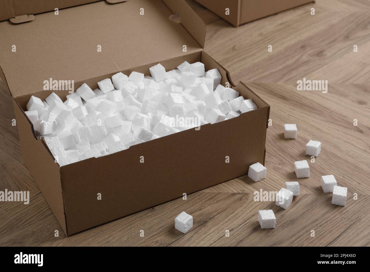 Cardboard box and styrofoam cubes on wooden floor Stock Photo Alamy