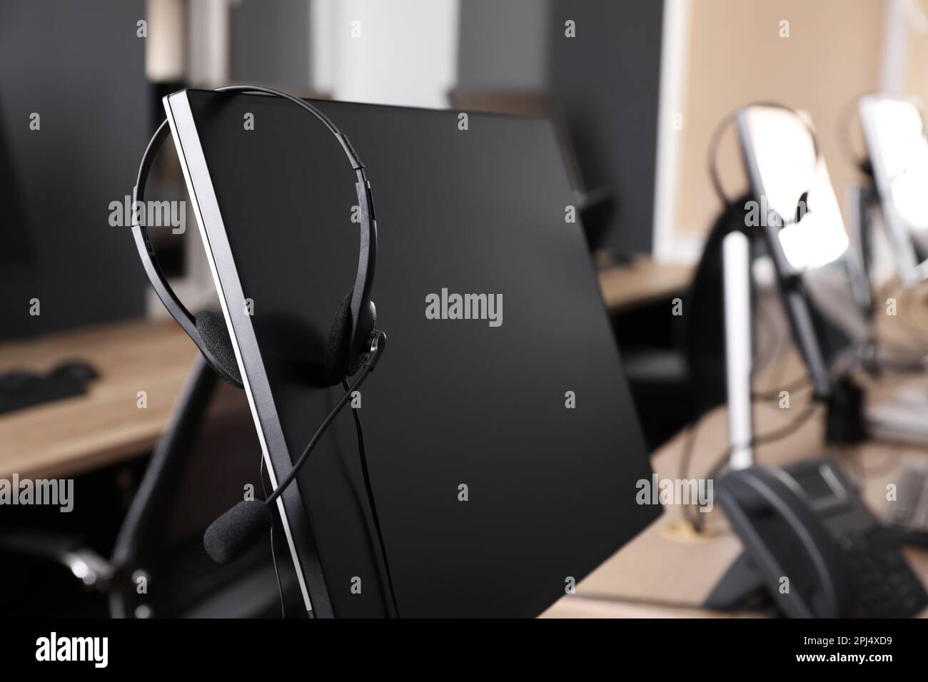 Modern computer with headset in office. Hotline service Stock Photo Alamy