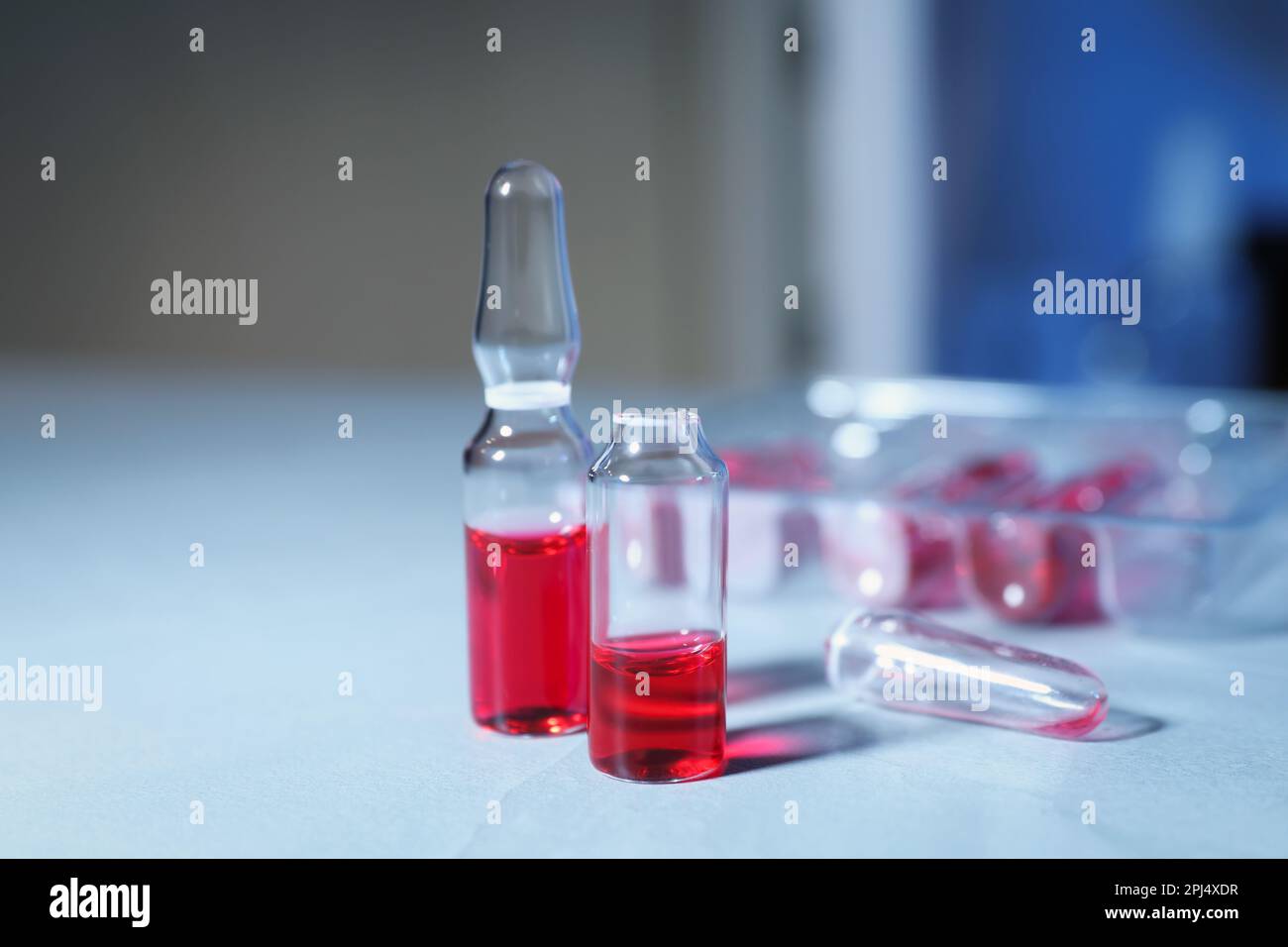 Pharmaceutical ampoules with medication on white table Stock Photo Alamy