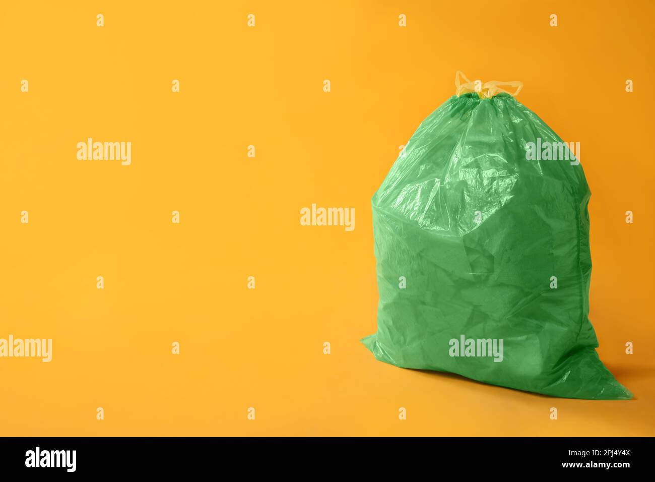 https://c8.alamy.com/comp/2PJ4Y4X/trash-bag-full-of-garbage-on-yellow-background-space-for-text-2PJ4Y4X.jpg