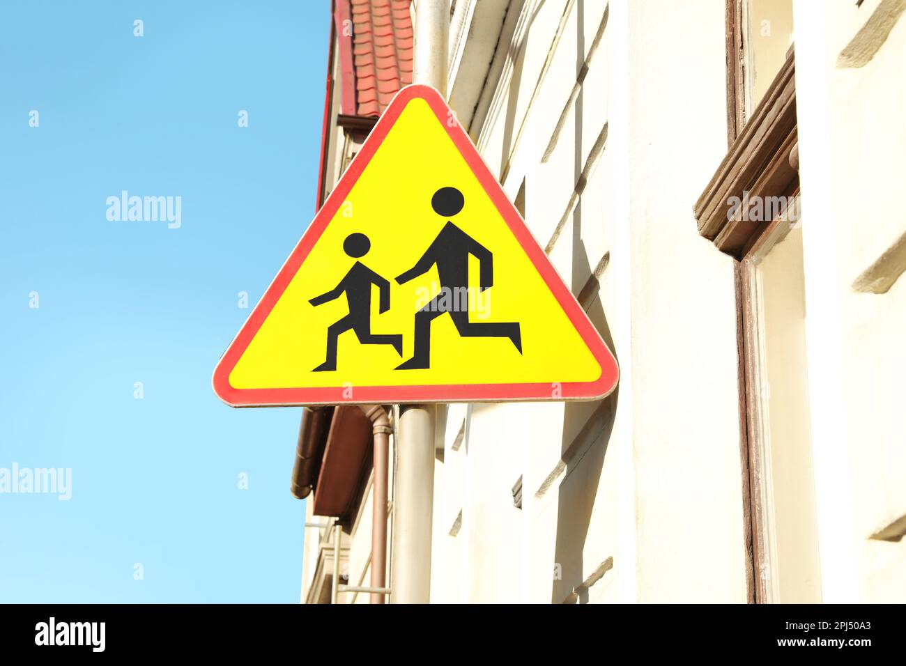 Traffic sign Children near building on sunny day Stock Photo