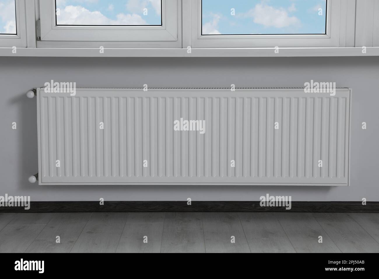 Modern radiator under window in office. Interior design Stock Photo Alamy
