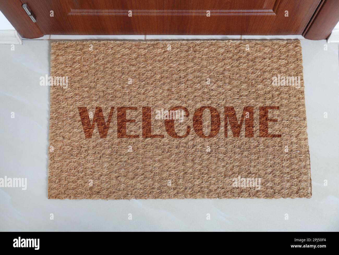 Door mat with word near entrance, top view Stock Photo Alamy