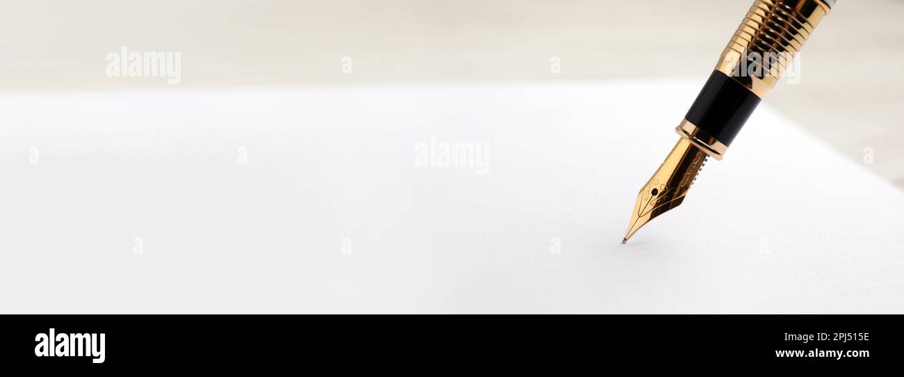 Writing with fountain pen on sheet of paper, closeup view with space