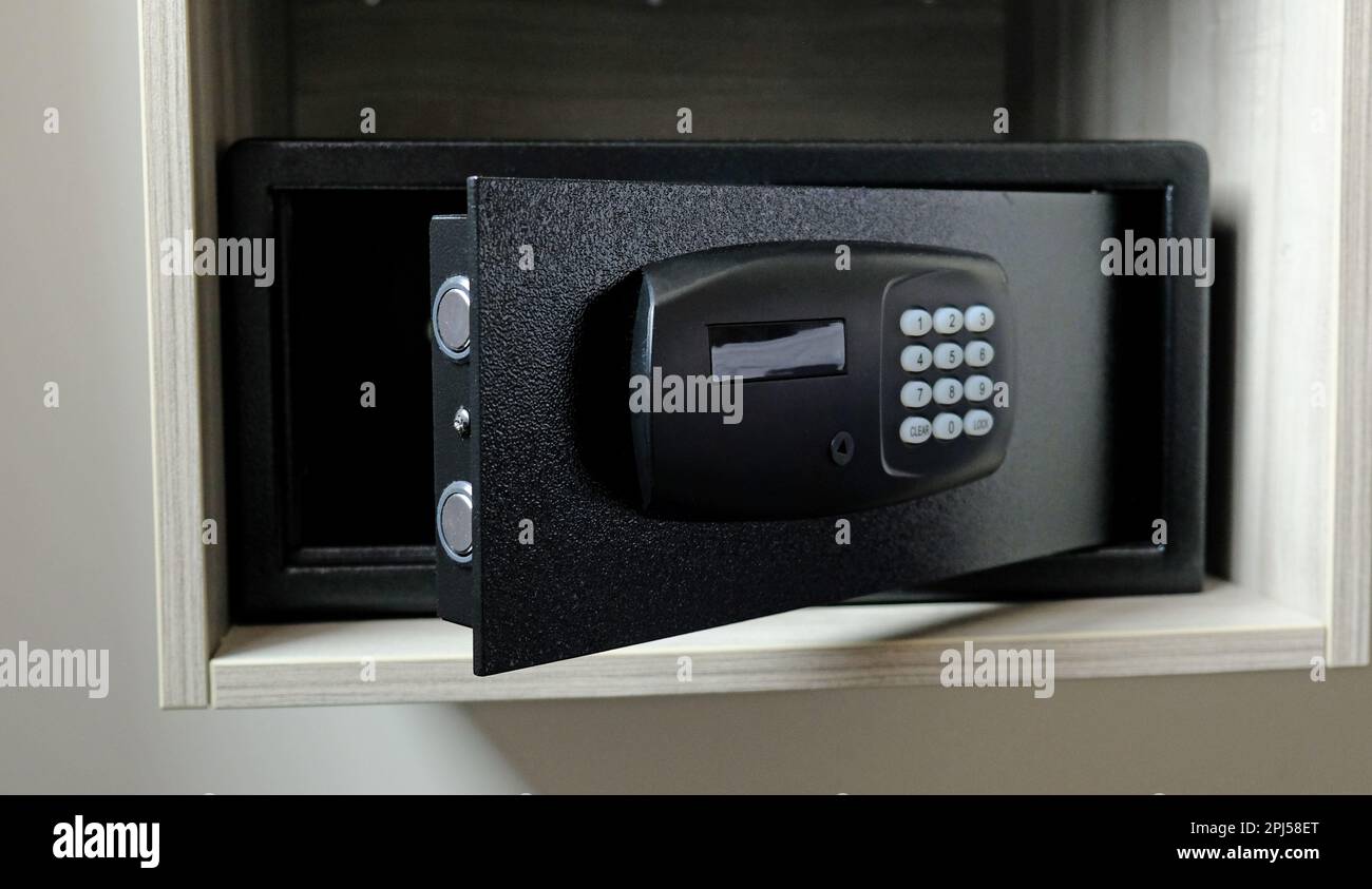 Metal safe box in the closet. Small narrow safe for keeping money or