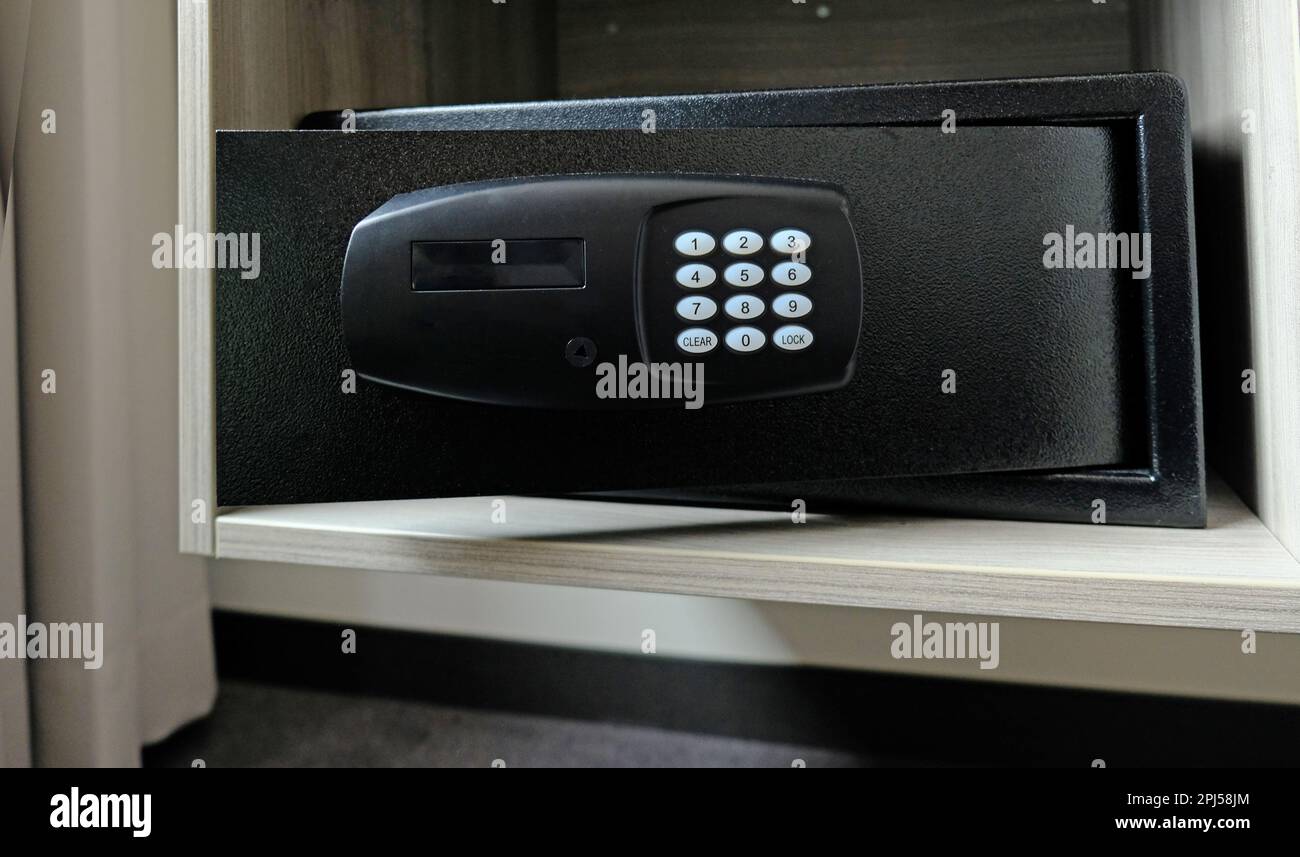 Metal safe box in the closet. Small narrow safe for keeping money or