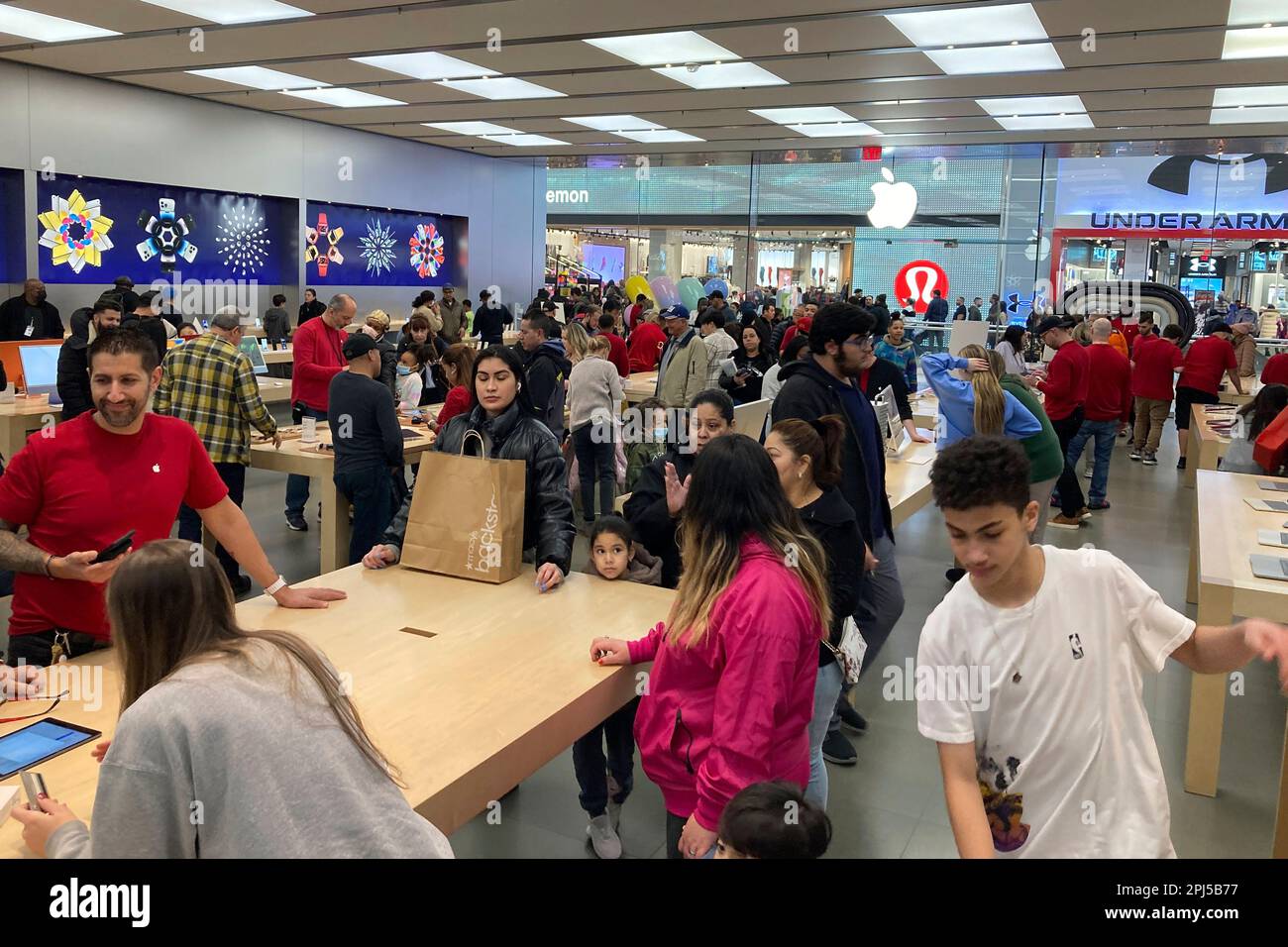 File - People shop at an Apple store in the Westfield Garden State Plaza  mall in Paramus, New Jersey, on Saturday, December 17, 2022. On Friday, the  Commerce Department issues its February