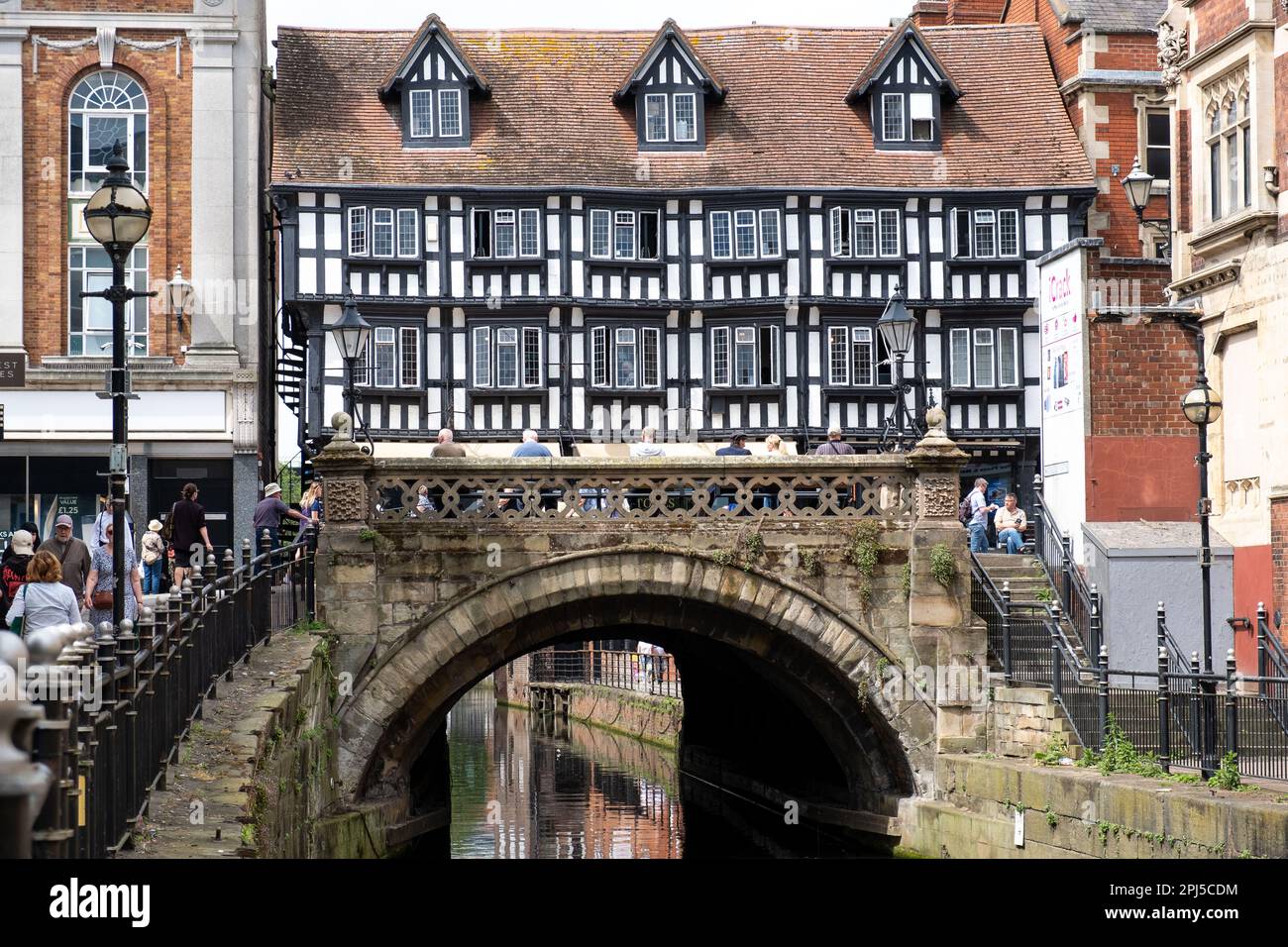 High Bridge across the River Witham in Lincoln City, England. Built in 1160, it It is the oldest bridge in the UK that still has buildings on it. Stock Photo