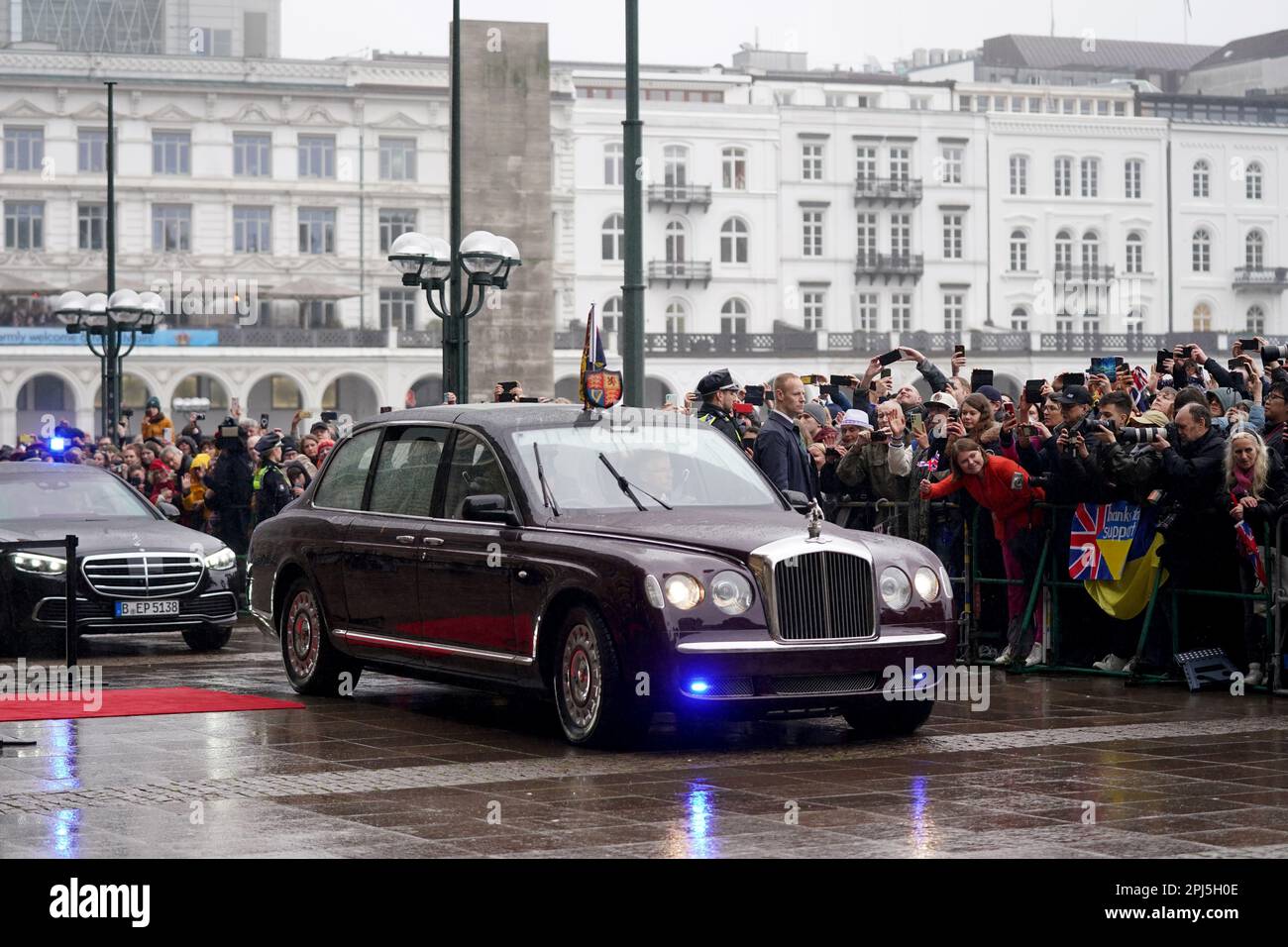 Hamburg, Germany. 31st Mar, 2023. The limousine of King Charles III of Great Britain drives on the Rathausmarkt in front of Hamburg City Hall. At the end of their three-day trip to Germany, the British king and his wife visit the Hanseatic city of Hamburg. Credit: Marcus Brandt/dpa/Alamy Live News Stock Photo