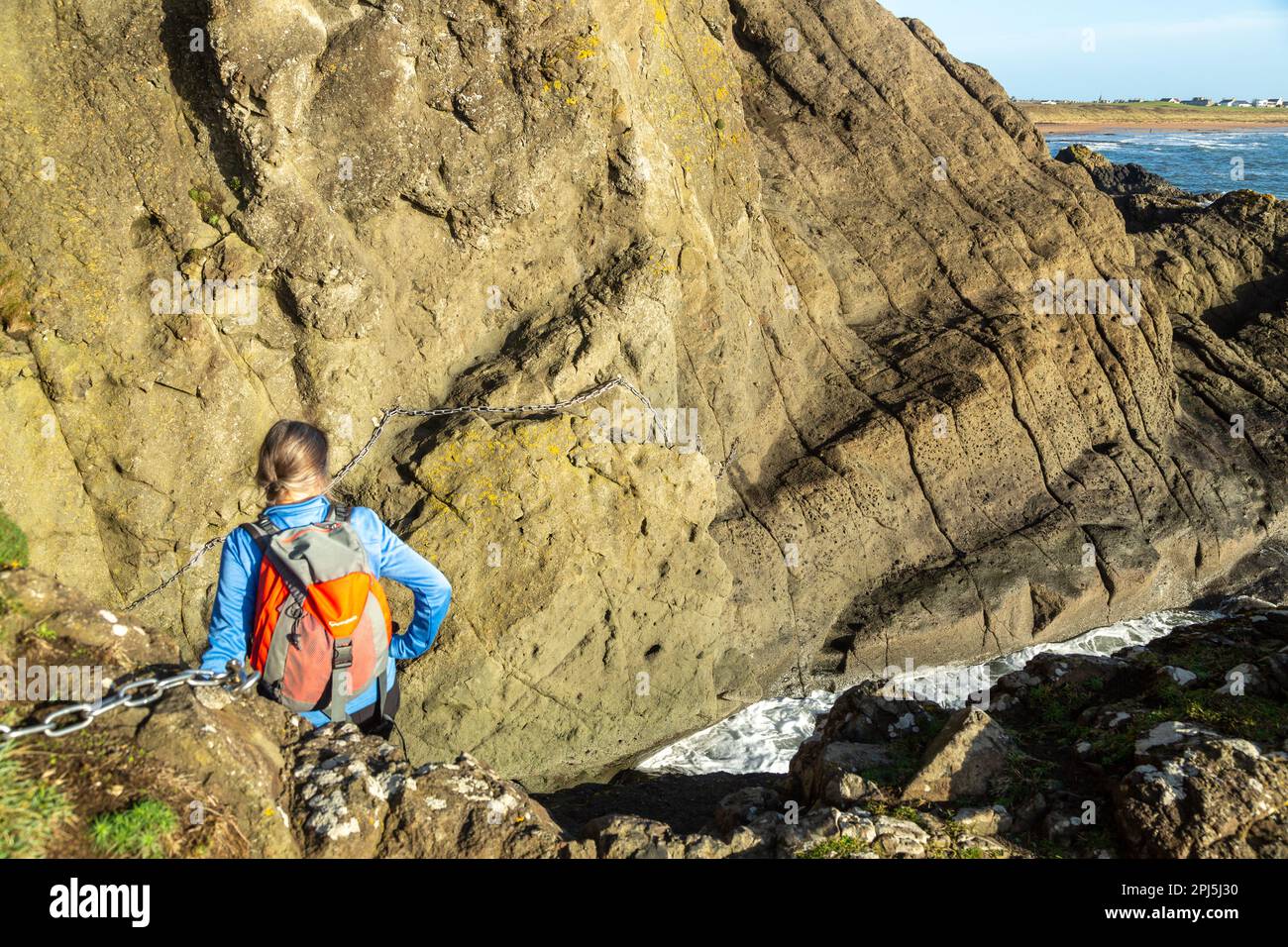 A person climbing a section of chains on the famous Chain walk at ...