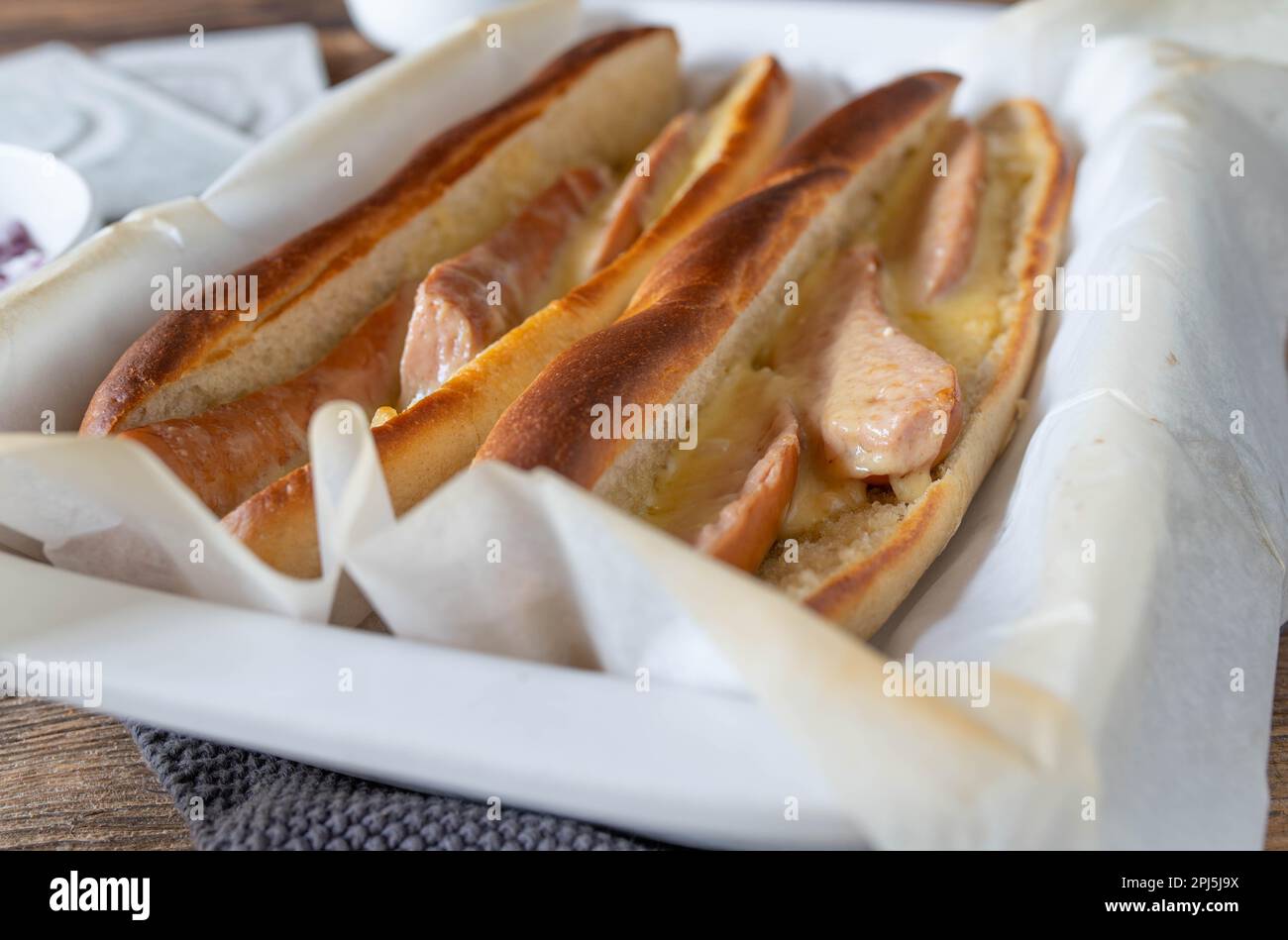 Sausage sandwich with german oven baked, boiled sausages, melted cheese